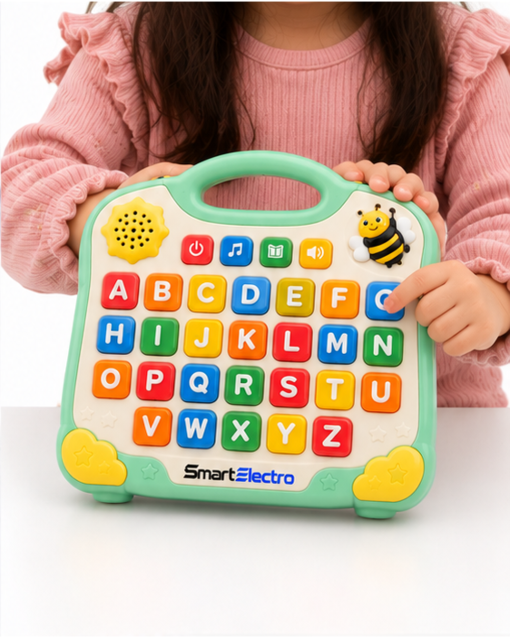 Child holding the mint green alphabet learning board on a table