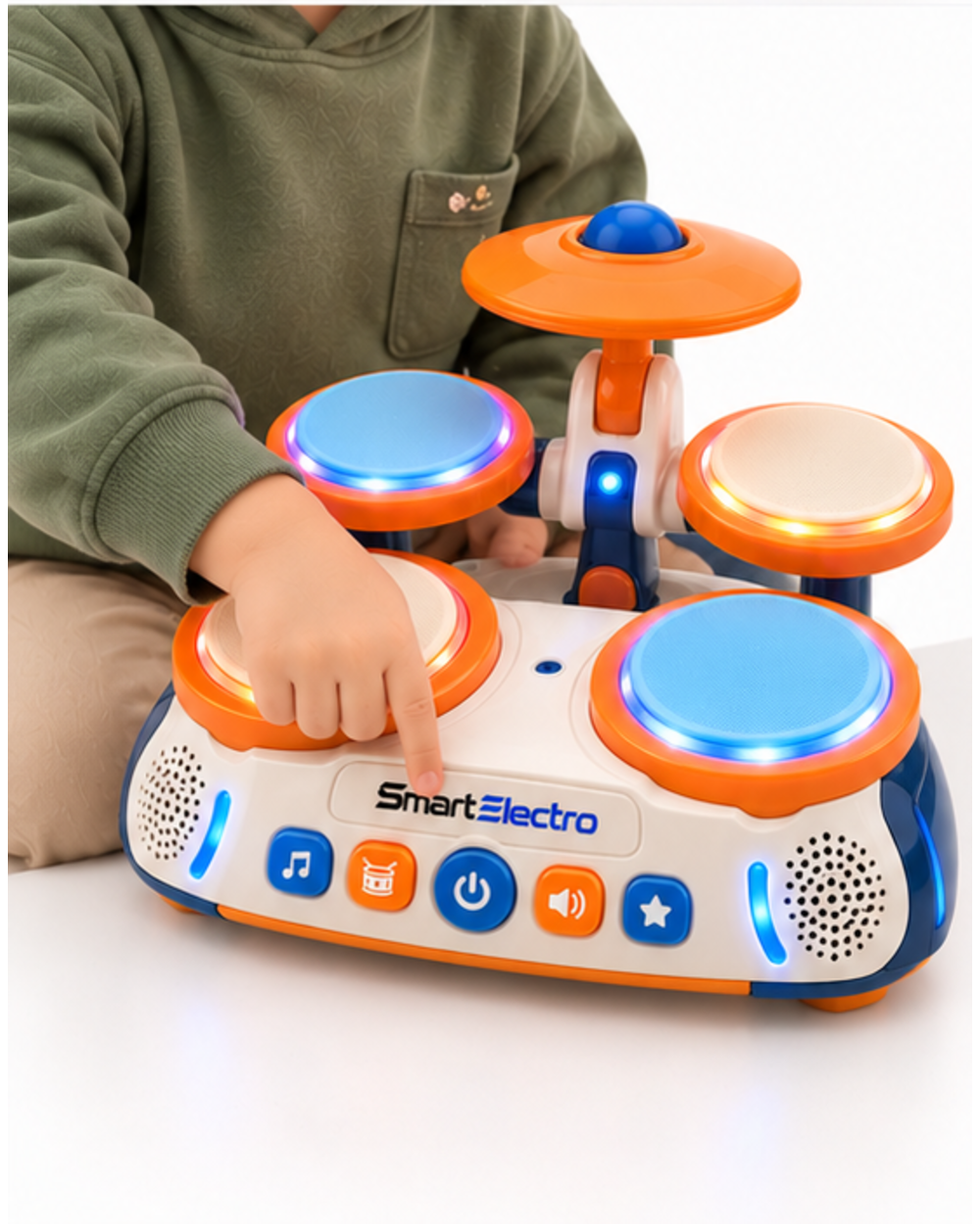 Child pressing a front panel button on the SmartElectro toy drum set